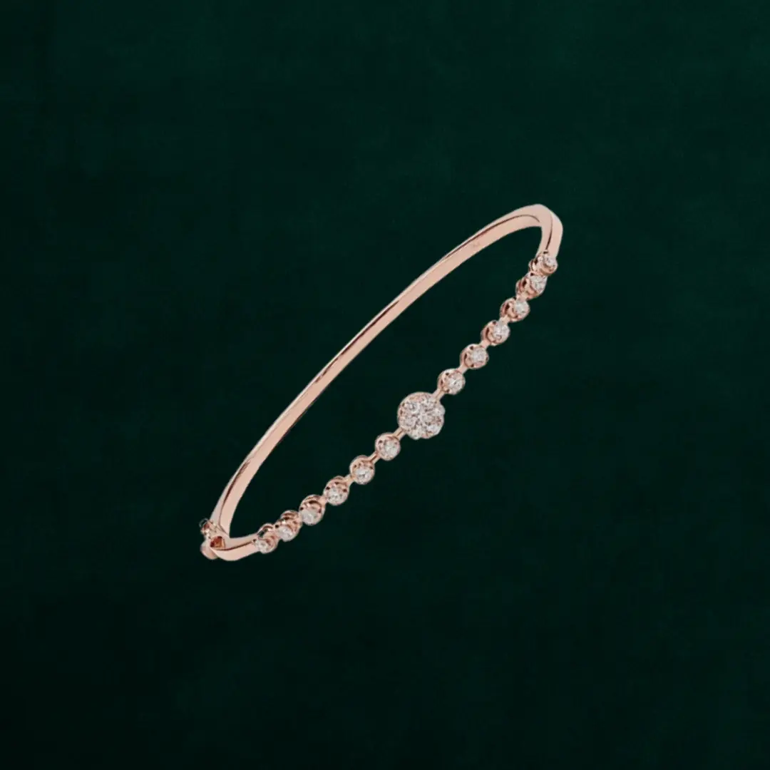 Slim, rose-gold-tone bangle detailed with a line of round CZ beads and a central cluster—adds subtle warmth and sparkle to stack or wear solo.