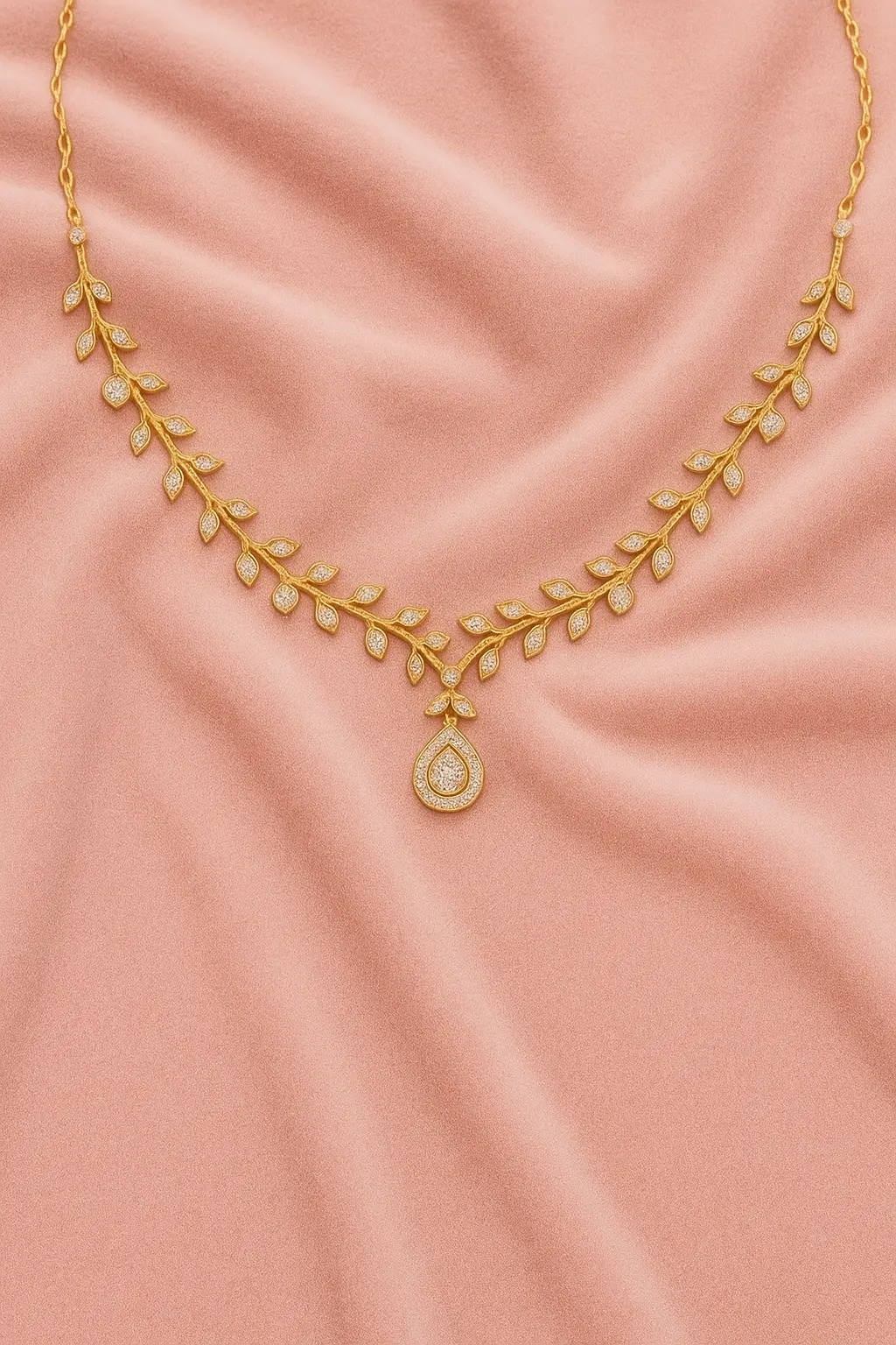 Turn heads with this elegant gold vine necklace, featuring intricate leaf designs and a radiant teardrop pendant. Displayed on a soft pink velvet background, it’s the ultimate expression of sophistication and class. Perfect for bridal or festive wear. Keywords: Gold vine necklace, teardrop pendant, bridal jewelry, leaf design necklace, pink velvet background